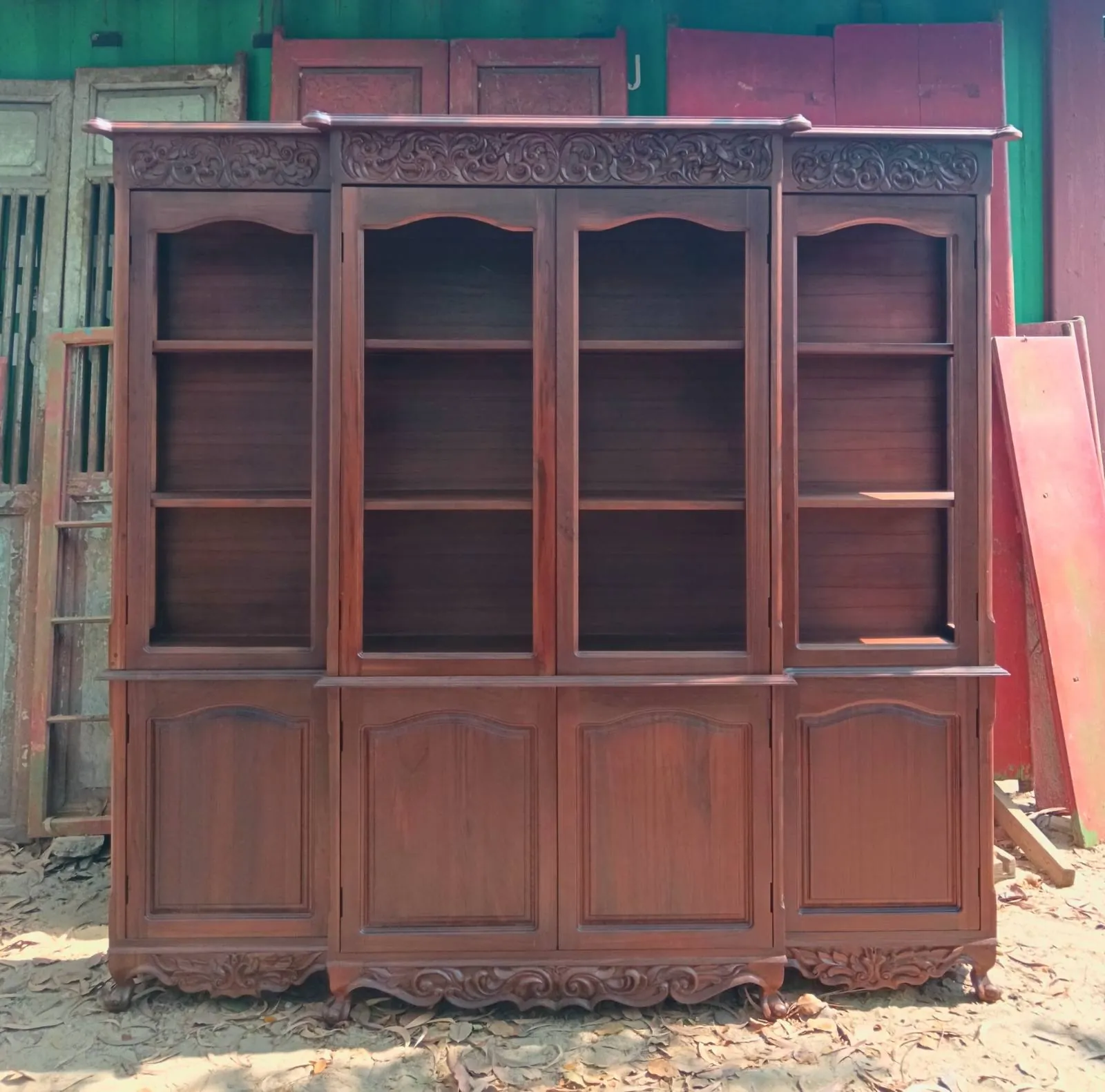 A large antique hutch cabinet in progress in the Mickey's workshop yard